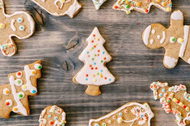 Close-up of Christmas gingerbread cookies on a wood texture. Fir-trees, little men and bells decorated with white glaze with multi-colored dots. Close-up of Christmas gingerbread cookies on a wood texture. Fir-trees, little men and bells decorated with white glaze with multi-colored dots. High quality photo Copyright: xZoonar.com NadtochiixVolodymyrx 17740063