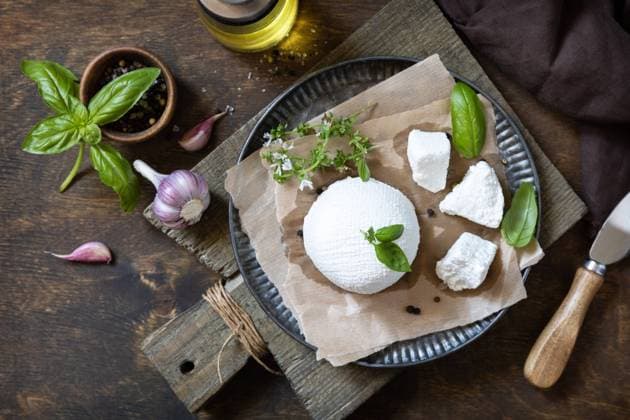 Homemade Italian ricotta cheese or cottage cheese with basil on a rustic table. Vegetarian healthy diet, fermentation food concept. View from above. Homemade Italian ricotta cheese or cottage cheese with basil on a rustic table. Vegetarian healthy diet, fermentation food concept. View from above. Copyright: xZoonar.com ELENAxHRAMOVAx 20062461