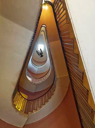 Creative Highlights World View from underneath of a staircase in pretty shape View from underneath of a staircase in pretty shape an a dove flying in the building Copyright: xZoonar.com LenaxIliopouloux 20280980