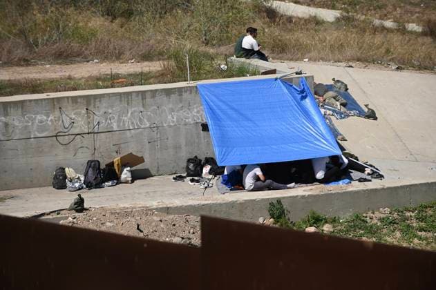 September 12, 2023, Tijuana, Baja California, Mexico: Around a hundred people are stuck between the two US-Mexico border fences dividing Tijuana and San Diego on Tuesday, September 12, 2023, as viewed from Tijuana, Mexico. The migrants are from countries in South America, Central Asia, Eastern Europe and Africa. All are seeking a chance to enter the US via asylum status, as some lost patience in the process of getting appointments through the CBP One application and crossed illegally out of desperation, some waiting months. Migrants claim that the appointment system is over saturated and is difficult to obtain access on the phone app. Tijuana Mexico - ZUMAm180 20230912_zip_m180_012 Copyright: xCarlosxA.xMorenox