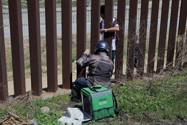 September 12, 2023, Tijuana, Baja California, Mexico: Around a hundred people are stuck between the two US-Mexico border fences dividing Tijuana and San Diego on Tuesday, September 12, 2023, as viewed from Tijuana, Mexico. The migrants are from countries in South America, Central Asia, Eastern Europe and Africa. All are seeking a chance to enter the US via asylum status, as some lost patience in the process of getting appointments through the CBP One application and crossed illegally out of desperation, some waiting months. Migrants claim that the appointment system is over saturated and is difficult to obtain access on the phone app. Tijuana Mexico - ZUMAm180 20230912_zip_m180_014 Copyright: xCarlosxA.xMorenox