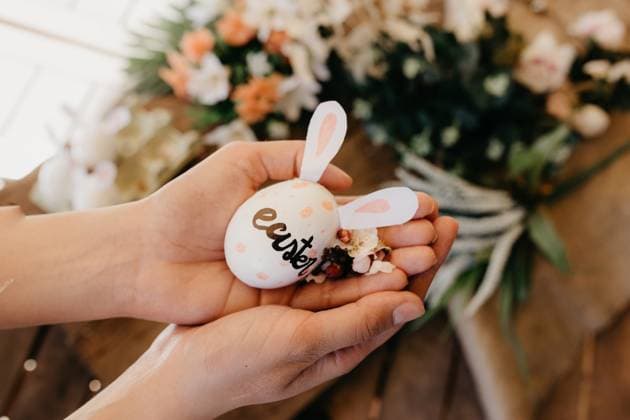 young woman holding an easter egg with rabbit ears painted by children with flowers Model Released ElenaGonzalez_ID3561_115798_015 Copyright: xElenaxGonzalezx