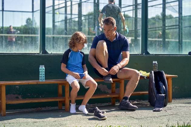 MR_ID14770_14478_MatthewJamesHudson.jpg, MR_ID14770_14477_PatrickDegroote.jpg Full body of serious man and boy sitting on bench in street while preparing for training with padel ball and rackets Model Released PhilippeDegroote_ID14770_448827_032 Copyright: xPhilippexDegrootex