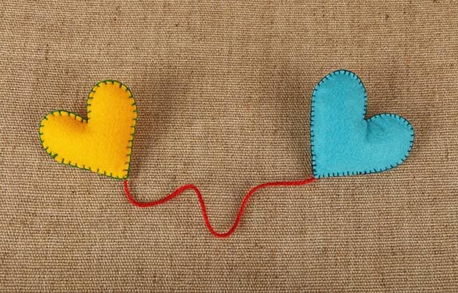 Creative Highlights Symbolfotos Two felt craft hearts, yellow and blue on canvas Felt craft and art, two handmade stitched toy hearts, yellow and blue, with red twine on canvas background, close up, low angle view Copyright: xZoonar.com AntonxEinex 10149592