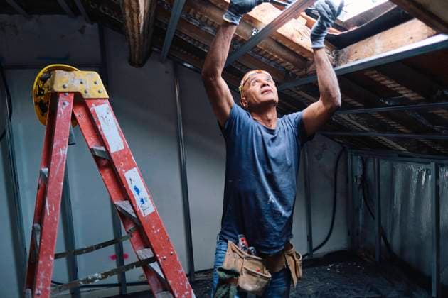 Mature construction worker repairing ceiling in attic model released, Symbolfoto property released, ASGF04304