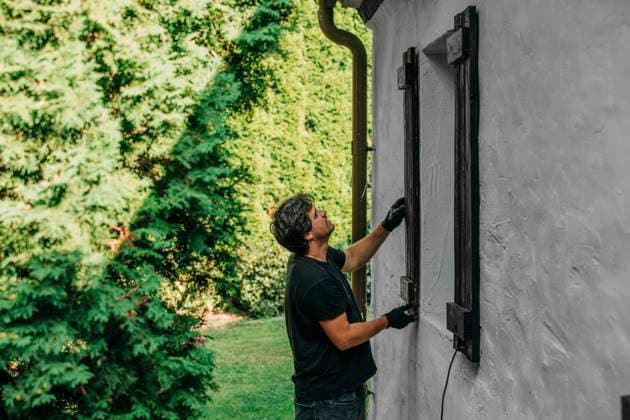 Man installing window of house in backyard model released, Symbolfoto property released, VSNF01395