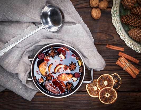 mulled wine with spices and pieces of fruit in a round aluminum pan, next to an iron scoop, top view , 30778716.jpg, wine, mulled, hot, christmas, red, winter, punch, alcohol, holiday, season, orange, celebration, traditional, drink, seasonal, wooden, beverage, spice, homemade, cinnamon, clove, spiced, closeup, citrus, decoration, food, pot, sweet, fruit, star, table, ingredient, slice, stick, anise, grog RECORD DATE NOT STATED