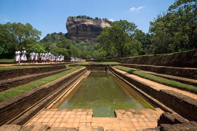 Sigiriya, Sri Lanka - March 23 2017: Students of a school class in white uniforms on a pathway at Lions Rock Sigiriya, Sri Lanka - March 23 2017: A line of students of a school class in white uniforms on a pathway at Lions Rock Copyright: xZoonar.com LoesxKieboomx 15676432
