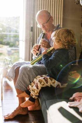 Family concert theme, child playing a Hoehner melodica grandfather and grandchild in pajamas Bonn Germany Copyright: xUtexGrabowskyx