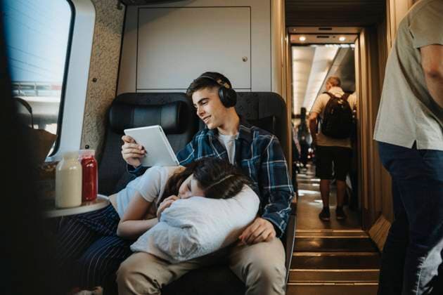 Girl resting on brother s lap using tablet PC while sitting on seat in train Sweden, Gothenburg, model released Copyright: xMaskotx , MA104046 MA104046