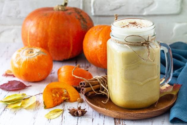 Autumn drink. Pumpkin spiced latte or coffee in glass on a rustic wooden table. Autumn drink. Pumpkin spiced latte or coffee in glass on a rustic wooden table. Copyright: xZoonar.com KHRAMOVAxxELENAx 20450351
