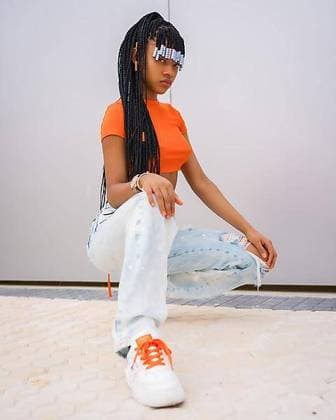 Creative Highlights Symbolbilder Eine junge Trap Tänzerin mit Zöpfen. Schwarzes ethnisches Mädchen mit orangefarbenem TShirt und Cowboyhosen auf grauem Hintergrund, in einer urbanen Rapper Pose mit Blick in die Kamera *** a Boy Trap Dancer with Braids Black Ethnic Girls with orange TShirt and Cowboy pants at grey Background, in a urban Rapper Pose with View in the Camera Copyright: imageBROKER/UnaixHuizi ibxuhu09694203.jpg ,model released, Symbolfoto ,property released