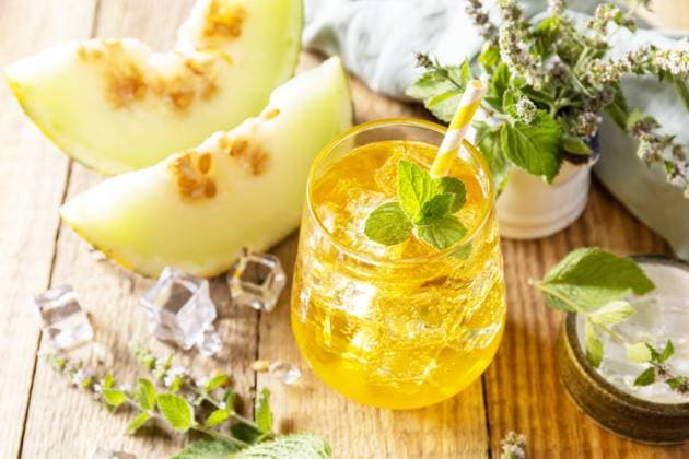 Fresh refreshing fruity summer drink, seasonal beverages. Melon lemonade in glasses with ice and mint on a wooden rustic table. Fresh refreshing fruity summer drink, seasonal beverages. Melon lemonade in glasses with ice and mint on a wooden rustic table. Copyright: xZoonar.com ELENAxHRAMOVAx 20552299