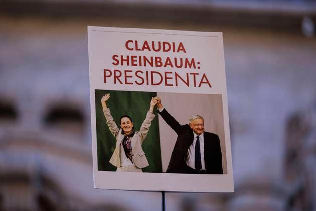 October 21, 2023, Los Angeles, California, USA: Supporter holds up a poster where current president Manuel Lopez Obrador holds up of Mexican presidential candidate for the party of Morena Claudia Sheinbaumhand naming her president during a rally on Saturday October 21, 2023 at the Million Dollar Theater in Los Angeles, California during a day visit. JAVIER ROJAS PI Los Angeles USA - ZUMAp124 20231021_zaa_p124_015 Copyright: xJavierxRojasx