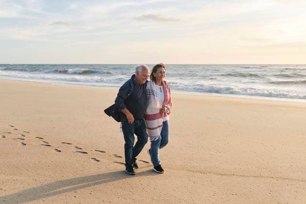 Happy senior couple walking on sand at beach model released, Symbolfoto, ASGF04097