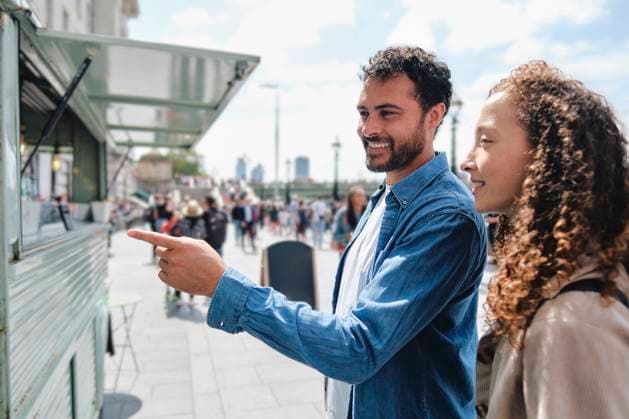Smiling woman with man gesturing near food truck on sunny day model released, Symbolfoto, ASGF04671