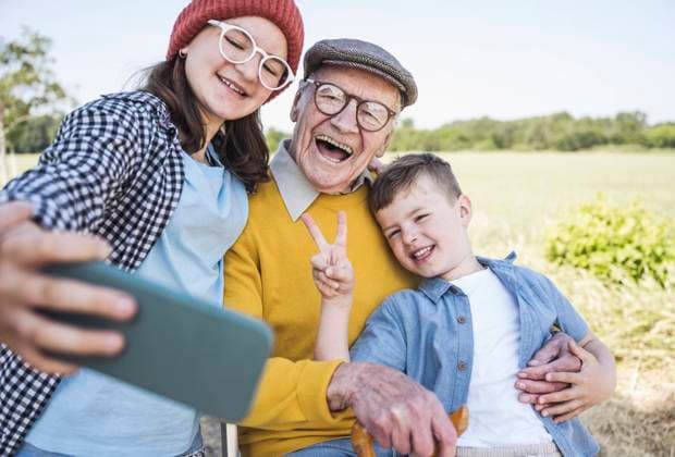 Happy girl taking selfie with brother and grandfather through mobile phone model released, Symbolfoto, UUF28975
