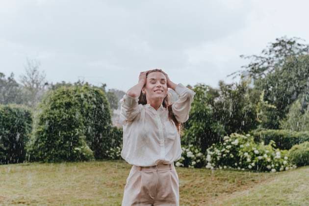Happy woman with eyes closed enjoying in rain at garden model released, Symbolfoto, YTF00932