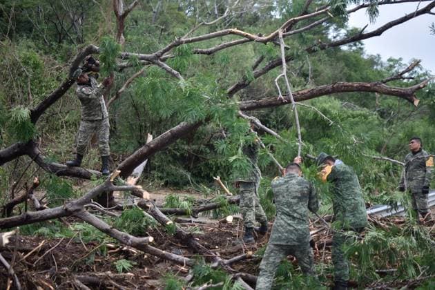 (231026) -- CHILPANCINGO, Oct. 26, 2023 -- Members of the Mexican Army clean up a road after Hurricane Otis ripped through Chilpancingo, state of Guerrero, Mexico, Oct. 25, 2023. Hurricane Otis battered much of the coastline along Mexico s southern Pacific Coast state of Guerrero after making landfall Wednesday morning as a category 5 storm, President Andres Manuel Lopez Obrador said Wednesday. (Photo by Xinhua) MEXICO-GUERRERO-CHILPANCINGO-HURRICANE OTIS DassaevxTellezxAdame 