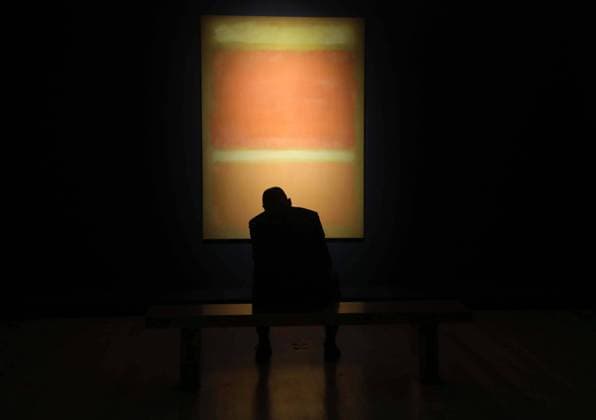 October 27, 2023, New York, New York, USA: A man sits in front of Mark Rothko Ã¢â‚¬ËœUntitled (Yellow, Orange, Yellow, Light Orange) oil on canvas 1955 seen at the exhibition for the upcoming ChristieÃ¢â‚¬â ¢s Fall 20 21 Marquee Week auction and is estimated to sell for $45 million. New York USA - ZUMAk03_ 20231027_zaf_k03_098 Copyright: xNancyxKaszermanx