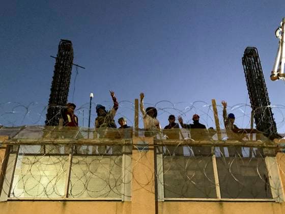 October 27, 2023, Nogales, Arizona, USA: Mexican workers on the new border wall project waive to Little Amal, the 12 foot puppet of a Syrian refugee girl, who is visiting the U.S. town of Nogales. Little Amal is on a 6000 mile journey across the United States to call attention to the plight of migrants and refugees while collaborating with local arts and community organizations. Nogales USA - ZUMAd155 20231027_znp_d155_025 Copyright: xSuexDorfmanx