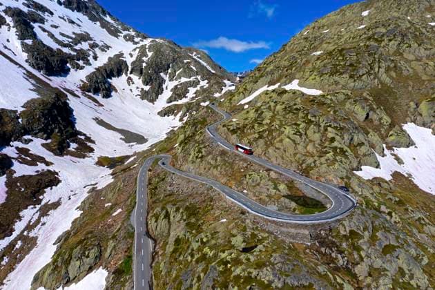 Coach on the pass road with hairpin bends on the approach to the Great St. Bernhard Pass, Valais, Switzerland Coach on the pass road with hairpin bends on the approach to the Great St. Bernhard Pass, Valais, Switzerland. Copyright: 61665_14_RM_CH_du0402_u