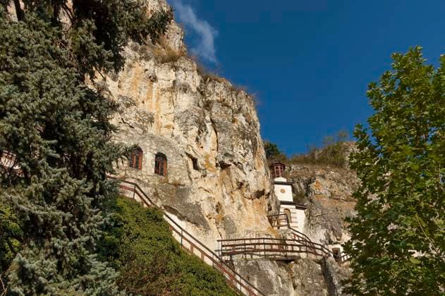 The rock monastery St Dimitrii of Basarbovo , Bulgaria. Church dome. Small rock church. Find it in the picturesque valley of the Rusenski Lom River, Bulgaria, Europe , 16085192.jpg, church, dome, ancient, architecture, art, building, house, close up, basarbovo, village, bulgaria, rock, stone, yard, carve, drawing, wall, fence, gate, chapel, cloister, monastery, christian, cross, culture, faith, dome, famous, god, historic, historical, religion, sky, clouds, trees, flowers, symbol, tourism, travel, bulgaria, RECORD DATE NOT STATED
