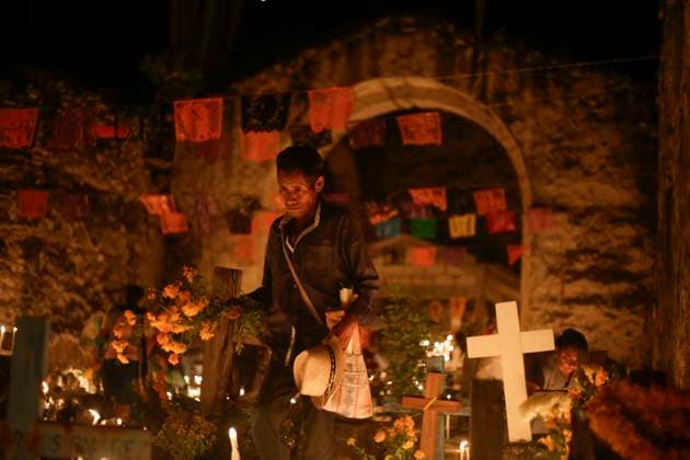November 3, 2023, San Juan Totolcintla, Guerrero, Mexico: A Nahua man from the indigenous community of San Juan Totolcintla, Guerrero, carries a bouquet of Cempaxochitl flowers into the remains of a pre-Hispanic church during the early hours of November 3 as part of the Day of the Dead traditions in the community. San Juan Totolcintla Mexico - ZUMAs310 20231103_zip_s310_009 Copyright: xLuisxExSalgadox