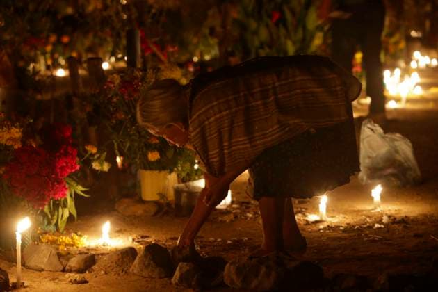 November 3, 2023, San Juan Totolcintla, Guerrero, Mexico: A Nahua woman from the indigenous community of San Juan Totolcintla, Guerrero, lights candles to her deceased saint in the early hours of November 3rd as part of the community s traditions, San Juan Totolcintla Mexico - ZUMAs310 20231103_zip_s310_013 Copyright: xLuisxExSalgadox