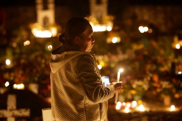 November 3, 2023, San Juan Totolcintla, Guerrero, Mexico: A Nahua woman from the indigenous community of San Juan Totolcintla, Guerrero, lights candles to her deceased saint in the early hours of November 3rd as part of the community s traditions, San Juan Totolcintla Mexico - ZUMAs310 20231103_zip_s310_015 Copyright: xLuisxExSalgadox