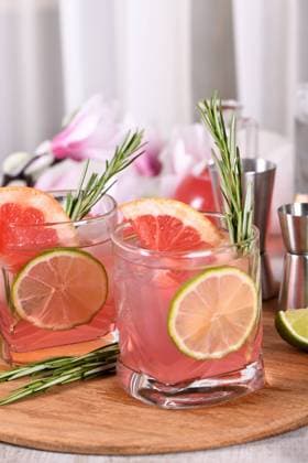 Pink Paloma cocktail red grapefruit with tonic Refreshing organic cocktail with grapefruit slice, lime and rosemary sprig in a glass Copyright: xZoonar.com MarynaxVoronovax 20648571