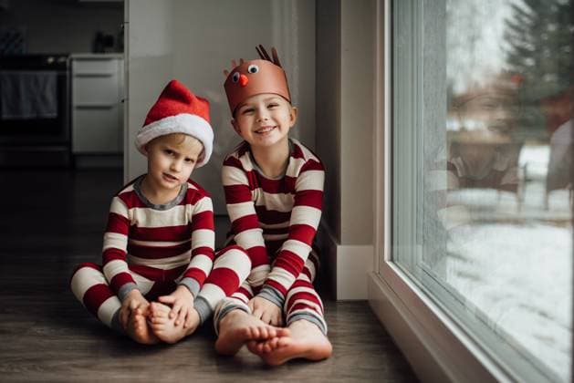 Two little boys sit next to snowy window wearing Christmas pajam United States, North Dakota, Bismarck CR_KIFR231113-1286858-01 ,model released, Symbolfoto