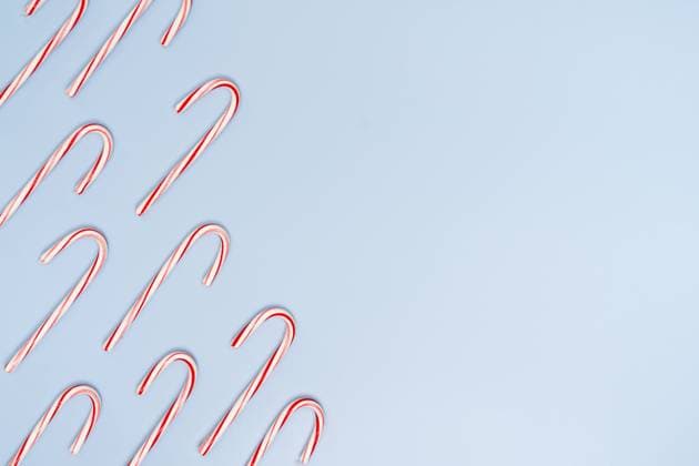 Candy Canes on Blue Background with Copy on the Right Jersey City, New Jersey, United States R_OBVP23111427-1287114-01