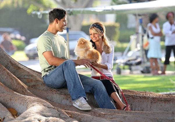 Nicole Richie films a music video part for her father 10771, LOS ANGELES, CALIFORNIA - Saturday July 22 2006. Actress Nicole Richie made an appearance in a music video shoot for her father Lionel Richie at a Los Angeles park. She filmed two shots, one walking a dog and the other with a young male co-star relaxing under a tree. In between takes she accidentally caught her hair in an electric fan while trying to keeping herself cool. She was wearing three quarter length jeans, white shirt, red belt and black high heels. Photograph: Andrew Shawaf, Andy Johnstone Pacificcoastnews.com. UK OFFICE: +44 131 225 3333 3322 US OFFICE: 1 310 261 9676, Credit:Andrew Shawaf, Andy Johnstone Avalon USA  Copyright: xAndrewxShawaf,xAndyxJohnstonex xAvalonx 0520212954