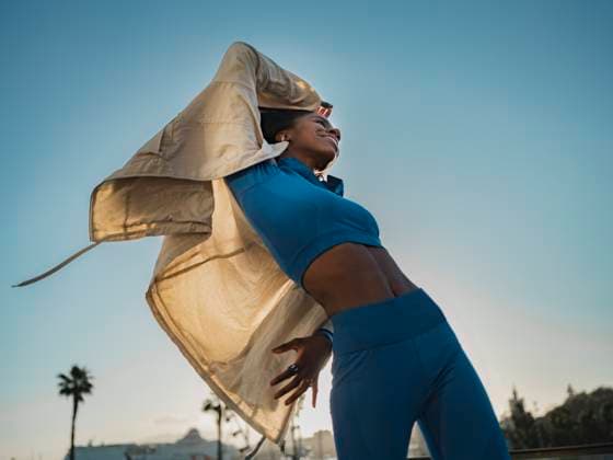 Creative Highlights Symbolbilder Carefree woman dancing with jacket under clear sky model released, Symbolfoto, Malaga Spain MFF09402