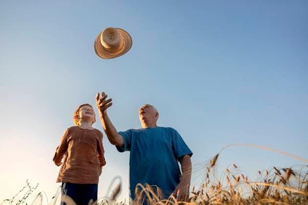 Grandson watching grandfather throwing straw hat under sky model released, Symbolfoto, MBLF00128