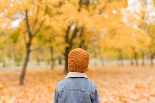 Boy wearing denim jacket and yellow knit hat at autumn park model released, Symbolfoto, ONAF00673