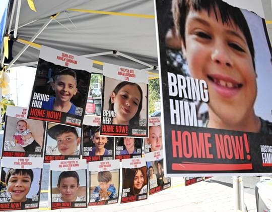 Posters of children being held hostage by Hamas in Gaza, hang outside the Israeli Defense Ministry in Tel Aviv on Thursday, November 23, 2023. Qatar announced that the Israel-Hamas hostage deal will begin at 7 a.m. Friday when the war will pause starting the agreement for Hamas to the release 50 Israeli hostages, children and women, and for Israel to release of 150 Palestinian security prisoners, women and male teenagers.  JER2023112302 DEBBIExHILL