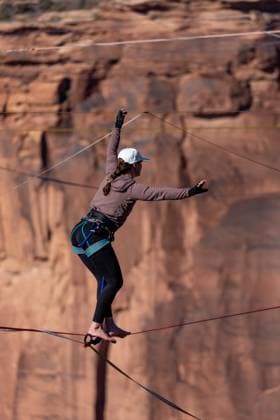 A young woman walking a highline at the GGBY World Highline Festival in Mineral Canyon near Moab, Utah. Moab Fruit Bowl Utah United States Copyright: xJonxG.xFullerx xVWPicsx JGF-sports-HighliningFestival-61