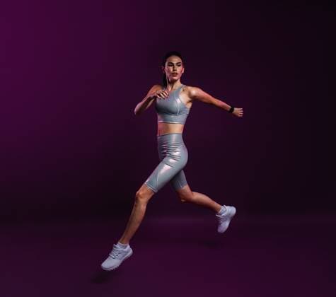 Creative Highlights Symbolbilder Young slim female in silver fitness attire running against a magenta background Young slim female in silver fitness attire running against a magenta background Copyright: xxArtemxVarnitsinx