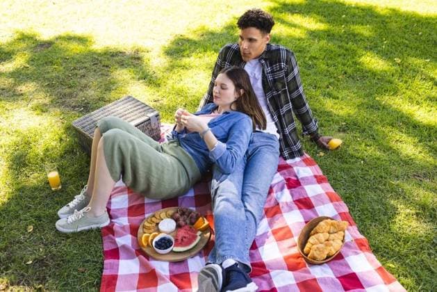 Happy diverse couple sitting on blanket and having picnic in sunny garden, copy space Happy diverse couple sitting on blanket and having picnic in sunny garden, copy space. Outdoors, expression, leisure, love, togetherness, food and drink and nature unaltered., model released, , property released, Cape Town, South Africa, 17.10.2023, 4920395.jpg, people,happy,diverse,couple,sitting,blanket,picnic,sunny,garden,copy space,outdoors,expression,leisure,love,togetherness,food drink,nature,unaltered,summer,young,lifestyle,beautiful,happiness,fun,together,outdoor,cheerful,family,green,adult,smile,park,day,smiling,person,cute,spring,copy,space,food,drink Young Adult,Woman,Female,White,Man,Male,Multiracial