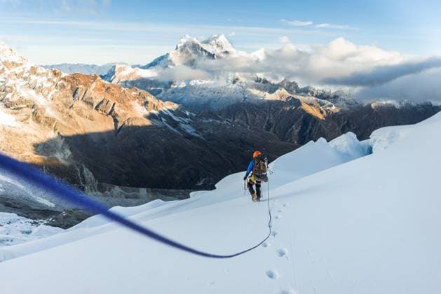 Creative Highlights Symbolbilder Man climbing on rope with mountain view Huaraz, Ancash, Peru CR_JABAFZ231126-228948-01 ,model released, Symbolfoto
