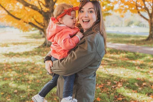 Mom smiling holding Toddler Girl on Fall Day Cockeysville, Maryland, United States R_KPXG231127-1288616-01 EDITORIAL USE ONLY