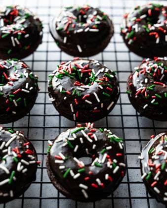 Close up of chocolate glazed donuts with Christmas sprinkles. Kingston, Ontario, Canada CR_DOHO231205D-1299993-01
