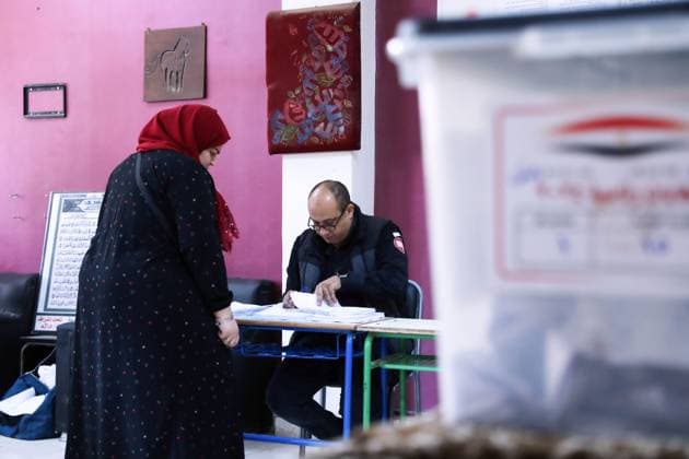 (231210) -- CAIRO, Dec. 10, 2023 -- A voter registers before voting at a polling station in Giza, Egypt, Dec. 10, 2023. Voting for Egypt s presidential election began at 9:00 a.m. local time (0700 GMT) on Sunday in Egypt, with four candidates contesting, including incumbent President Abdel-Fattah al-Sisi. Voting spans from Dec. 10 to Dec. 12, with each day allowing 12 hours to cast ballots. Overseas Egyptian voters had previously cast their ballots from Dec. 1 to Dec. 3. ) EGYPT-PRESIDENTIAL ELECTION AhmedxGomaa 