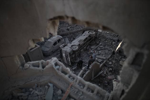 (231211) -- MAGHAZI REFUGEE CAMP, Dec. 11, 2023 () -- People inspect the damage after an Israeli airstrike in Maghazi refugee camp, central Gaza Strip, on Dec. 11, 2023. The Ministry of Health in Gaza announced on Monday that the Palestinian death toll in the Gaza Strip has exceeded 18,000 as a result of the Hamas-Israel conflict since Oct. 7. () MIDEAST-GAZA-MAGHAZI REFUGEE CAMP-AIRSTRIKE Xinhua 