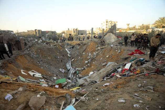 People search house rubble for items to salvage following an early morning Israeli strike in Rafah in the southern Gaza Strip, on Tuesday, December 12, 2023, At least 22 people have been reportedly killed, including seven children, in the bombing by Israel in Rafah on Tuesday. Global calls for a ceasefire have been ignored by Israel and the United States, as humanitarian aid operations have collapsed warning of starvation and disease amongst the Gaza population.  GAZ2023121215 IsmaelxMohamad