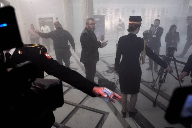 Far-right lawmaker extinguishes Hanukkah candles in Polish parliament Warszawa 12.12.2023. Sejm, posiedzenie. Uroczystosc zapalenia swiec chanukowych organizowana przez Chabad Lubawicz. Uroczystosc zaklocil posel Grzegorz Braun (Konfederacja) dokonujac zgaszenia swiec za pomoca gasnicy przeciwpozarowej.,Image: 829085466, License: Rights-managed, Restrictions: , Model Release: no, Credit line: Adam Chelstowski Forum Grzegorz Braun, member of far-right political alliance Confederation, used a fire extinguisher to disrupt the candle lighting ceremony, in Warsaw, Poland December 12, 2023. 829085466  0829085466