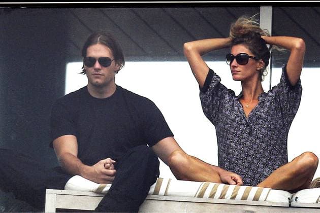 VIVA BRAZIL! Tom Brady and Gisele Bundchen enjoy each other s company while watching a street carnival with friends from their balcony 52075, RIO DE JANEIRO, BRAZIL - Monday March 7, 2011. VIVA BRAZIL! Tom Brady and Gisele Bundchen enjoy each other s company while watching a street carnival with friends from their balcony in Brazil. Brady is seen removing the protective wrap from his right foot, but still wincing as he rubbed it. The football player, wearing a headband to keep his long hair out of his face, is seen drinking from a coconut and dancing with Gisele, who looked like she was enjoying herself with friends and family close by. E-TABLET IPAD & MOBILE PHONE APP PUBLISHING REQUIRES ADDITIONAL F  Copyright: xWagnerxAz,xPacificCoastNews.comx xAvalonx 0524949901
