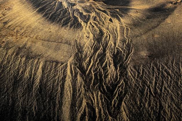 Intricate patterns on the sandy beach of the Occidental Coast in Asturias, Spain, captured during sunset, showing the play of light on the natural textures. Model Released DavidJerez_ID18012_542461_009 Copyright: xDavidxJerezx